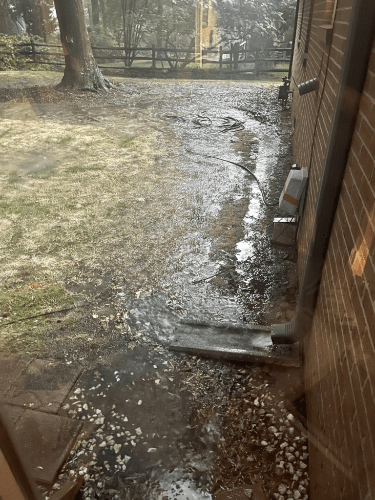 water from gutters going coming out onto ground near house