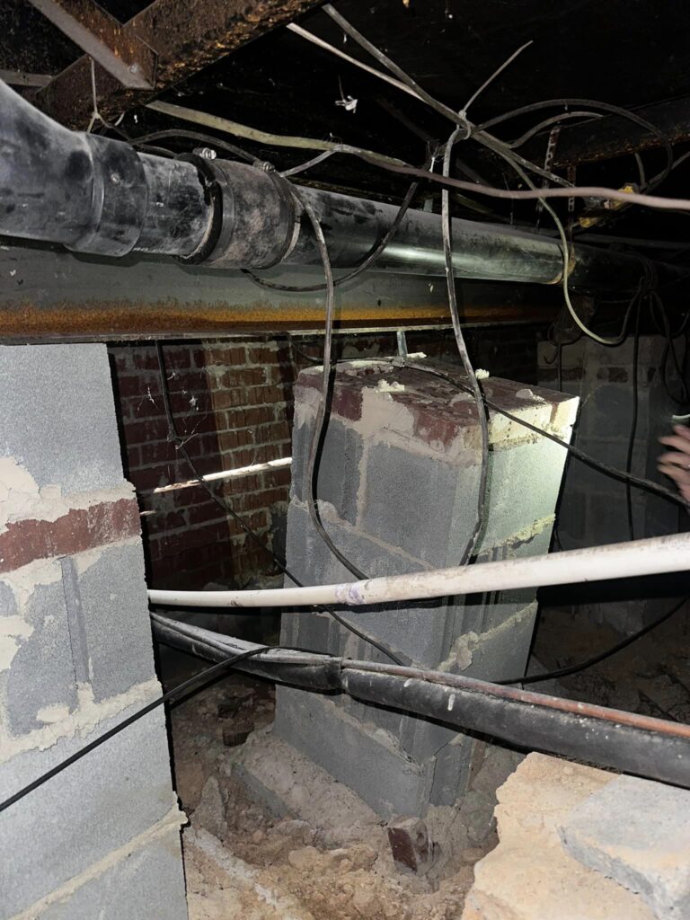 pier of a pier and beam foundation falling over due to water damage in crawl space