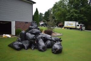 crews removing crawl space insulation loaded into black trash bags